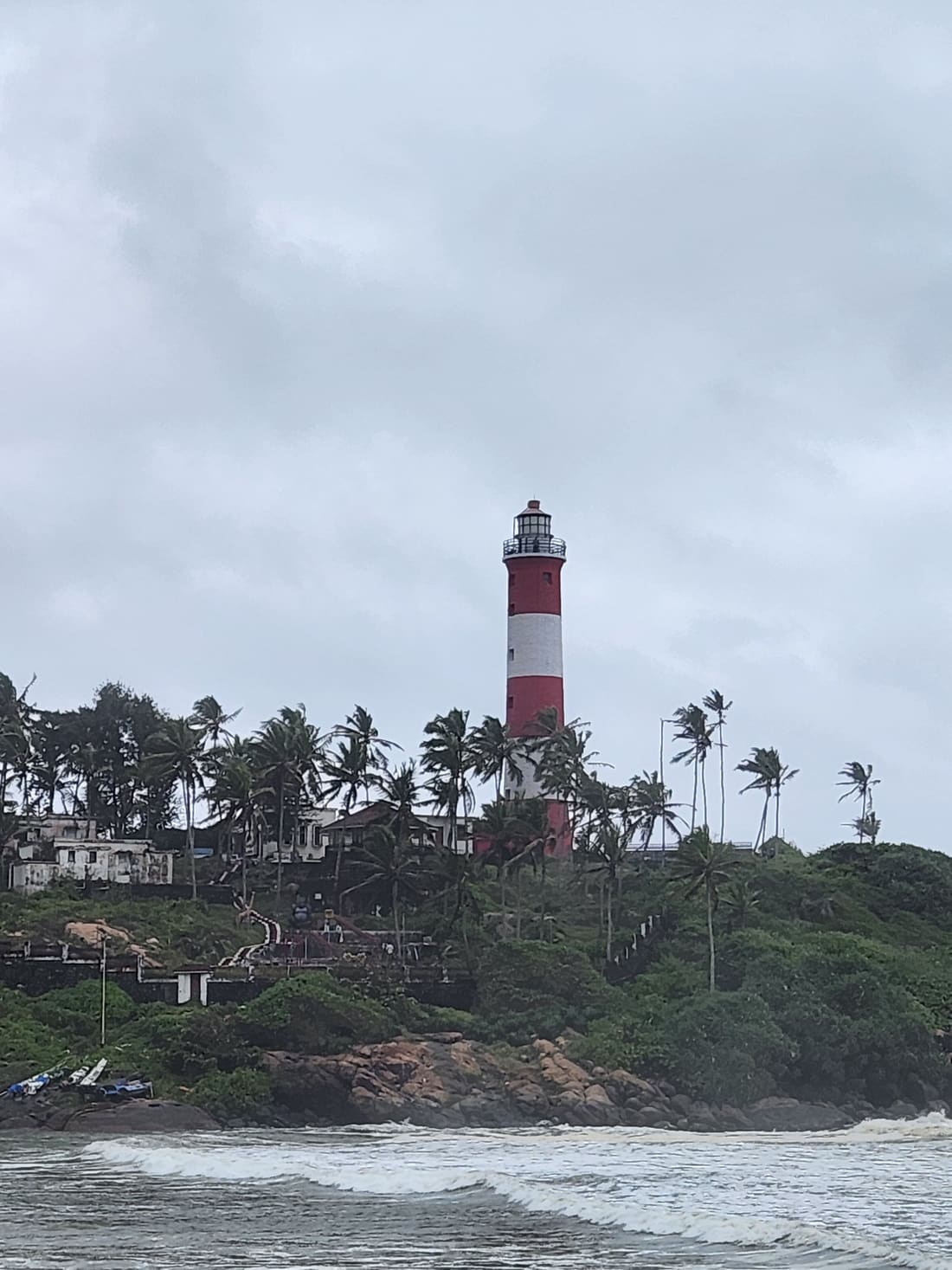 Kovalam lighthouse rising above a palm-covered headland